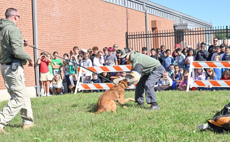 Cpl. Chad Morris, left, holds onto Ace as he detains Tyler Botchie during the K-9 demonstration.