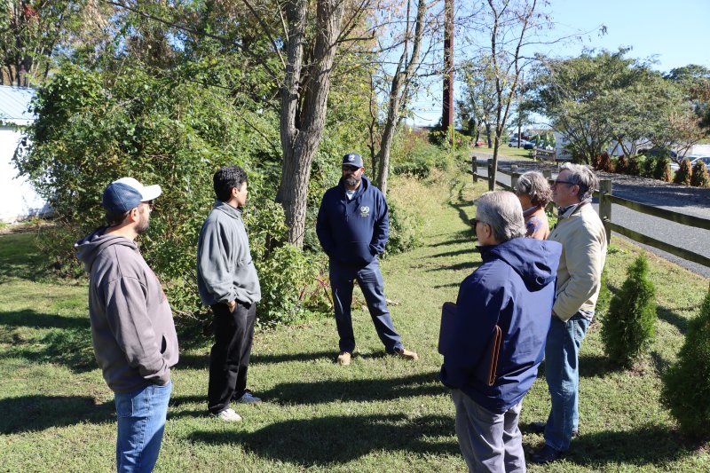 Dick Bryan hosted a meeting of officials in his backyard Oct. 16. He wanted them to see his and his neighbor’s properties that flood during heavy rain storms. Shown clockwise from left are Michael Deldeo, property owner; Salvador Alacron, Rep. Alonna Berry’s office; Matt Messina, Sussex Conservation District; Janet Reeves, Lewes assistant city manager; Dick Bryan, property owner; and Jim Elliott, Sussex Conservation District. BILL SHULL PHOTO