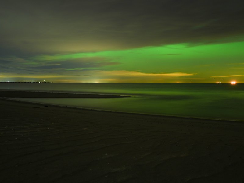Beneath the cover of clouds, a shade of green shines in the Lewes sky over Delaware Bay Nov. 11.