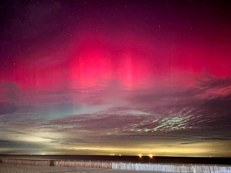 A pink glow from the northern lights accentuates the stars shining over Lewes Beach around 11:30 p.m., Nov. 11.