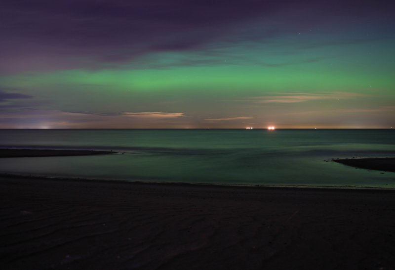 The sky over Lewes casts a green-blue glow onto the bay around 10:30 p.m., Nov. 11.