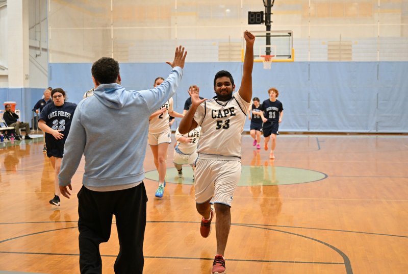 Jwalit Patel runs to give a high five to referee JD Maull.