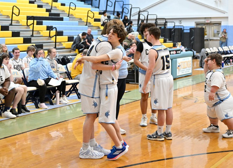 Xavier Zimmer, right, gets a hug from unified partner Bennett Steinmann.