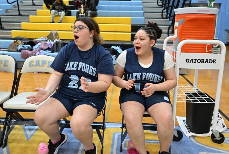 Lake’s Hannah Alexander, left, and Raven Jobes cheer on their team.