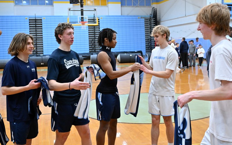 The two teams trade game jerseys for friendship.