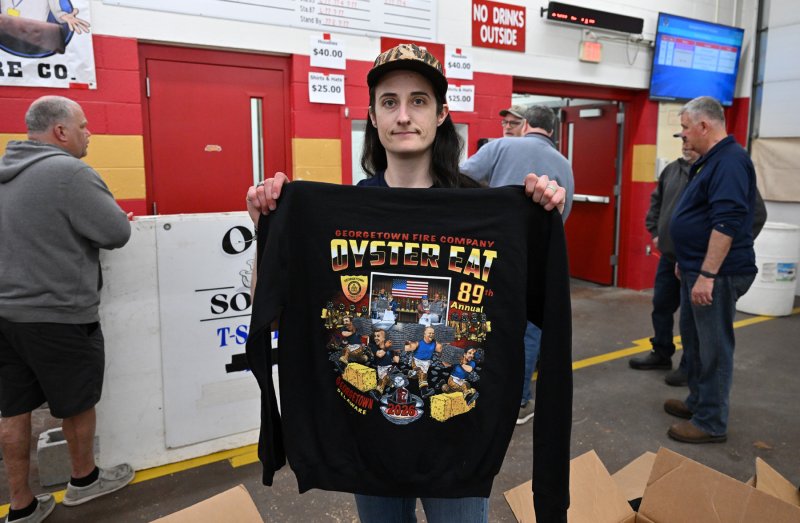 Member Brenda Murphy unboxes the sweatshirts up for purchase at the event.