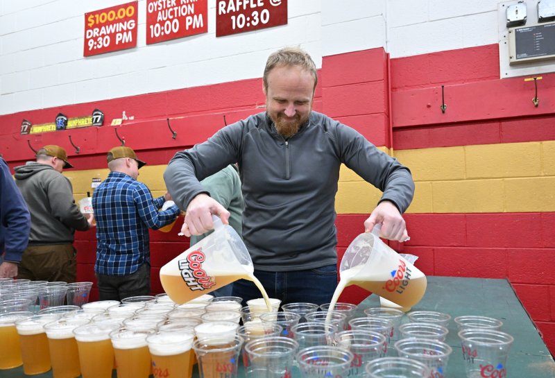 Stephen Pfaffenhauser uses his double-fisted pour to get the beer ready for the event.