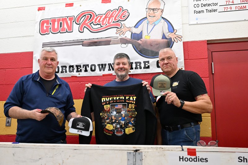 Selling the T-shirts, sweatshirts and hats are (l-r) fire company members Eric Swanson, Chief Engineer Kevin Thawley and Ladd Dick.