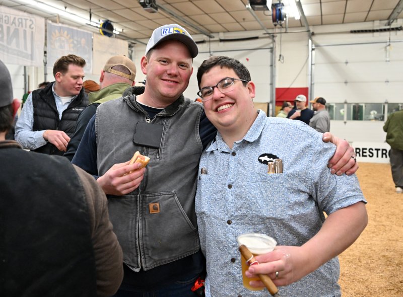 Friends Ben McCall, left, and Shaun Palmer enjoy a cigar and a beer.