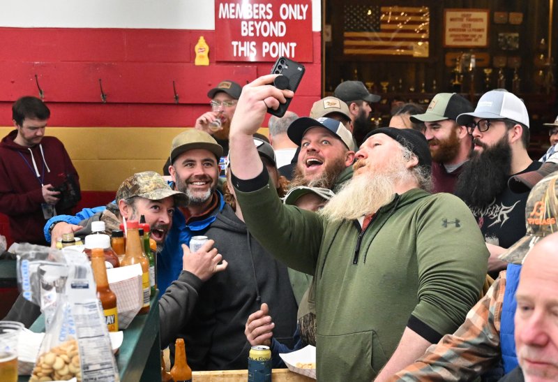 A group of happy oyster eaters get a selfie remember the evening.