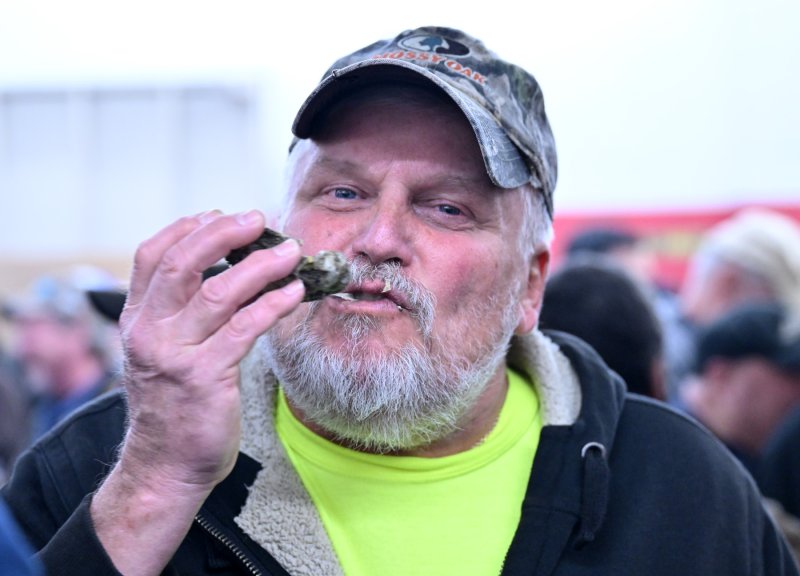 Carl Brzozowski slurps a tasty oyster.