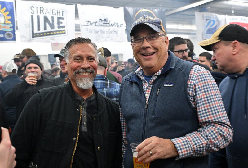 Former Rep. Steve Smyk, the chief deputy for Sussex County, left, has a moment with Ken Adams, who bought the oyster knife for $6,000.