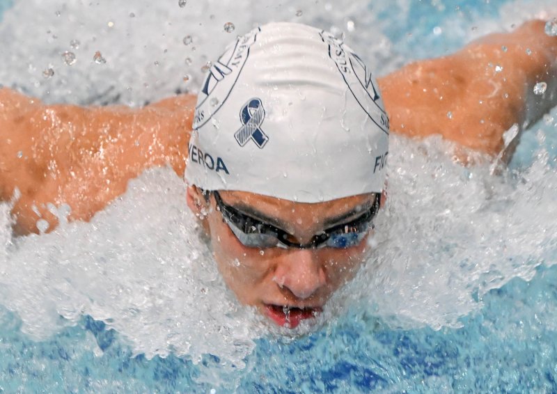 Sussex Academy senior Angel Figueroa swims the fly leg of the medley relay. He and his teammates Michael Whitaker, Jackson Proctor and Christian Wright placed seventh. An ALS bow on their cap is to honor coach Tom Martiner’s brother who is suffering from the disease.