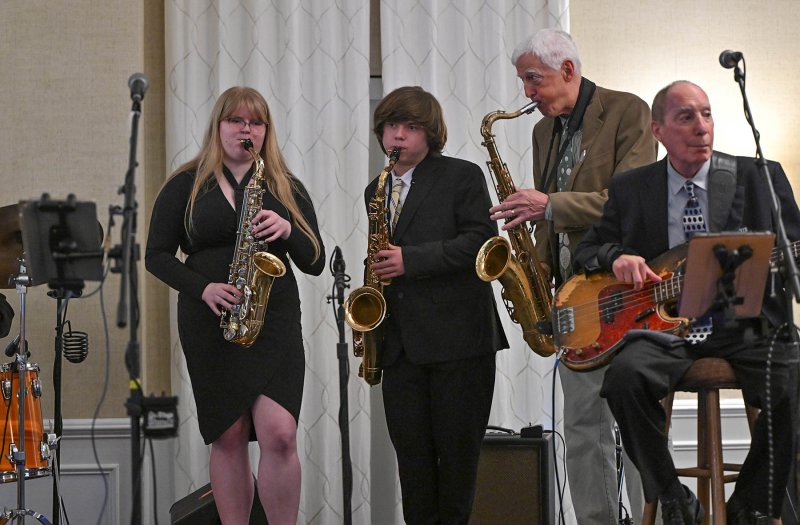 Cape Henlopen band members Julia Burrell and Reed Williamson sit in on sax with 5th Avenue band members Monte Wisbrock on saxophone and Jeff Cooper on bass at the 2025 Concert for the Kids. DAN COOK PHOTO