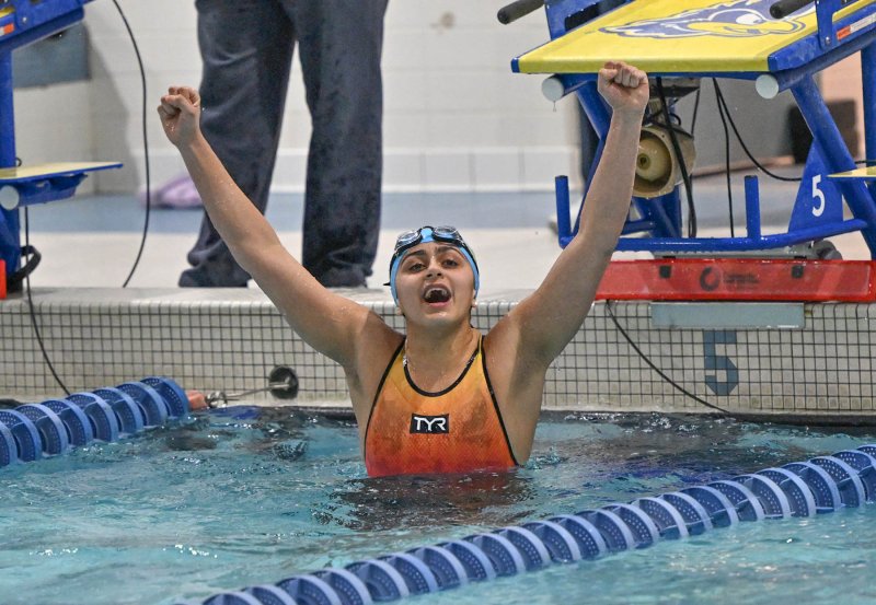 Cape junior Mia Jaoude celebrates her first-place finish in the 50 free.