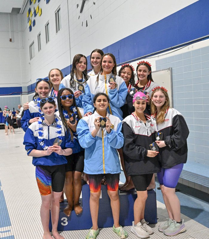 The podium for the 200 free relay presents the Cape squad of Lily Touw, Isla Touw, Sidney Caldwell and Mia Jaoude on the gold spot, Ursuline on the second level and Charter School of Wilmington on the third tier.