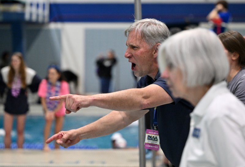 Cape coach Bill Geppert cheers on his 400 free relay team.