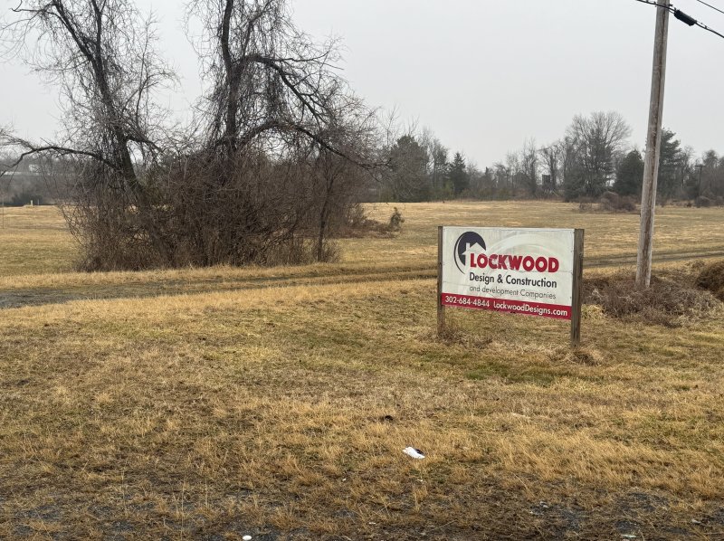 A sign for Lockwood Design & Construction sits on the property of the proposed Knight Crossing in Milford. NICK ROTH PHOTO