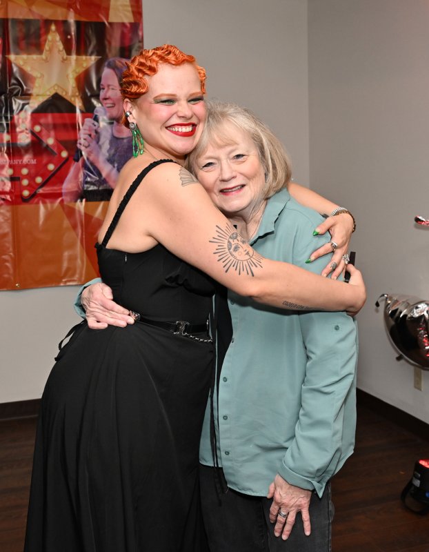 CAMP Rehoboth volunteer Linda Kemp, right, gets a hug from singer Yoli Mayor.