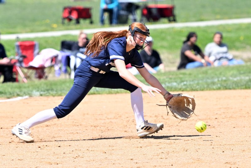 Sussex Academy freshman third baseman Emma Orlen makes a diving attempt for a grounder at the hot corner.