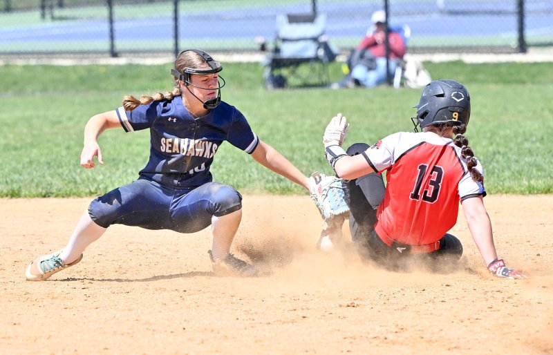 Freshman shortstop Danica Bergh just misses the tag on Conrad’s Alexis Davis.