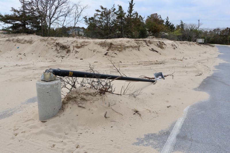 A light pole at the south end of the Savannah Beach parking lot was knocked over during the sand removal.
