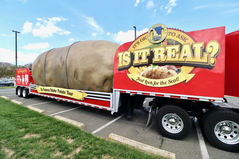 The sign on the truck asks, “Is it real?” The giant potato is actually made of fiberglass and weighs 4 tons.