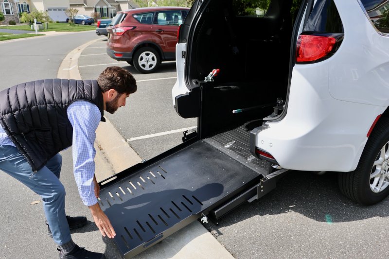 Javier Ruiz pulls down the wheelchair ramp on the Sussex Transport Care van. Ruiz said he will pick up patients at their homes, take them to a medical appointment, stay with them the whole time, then drive them home.