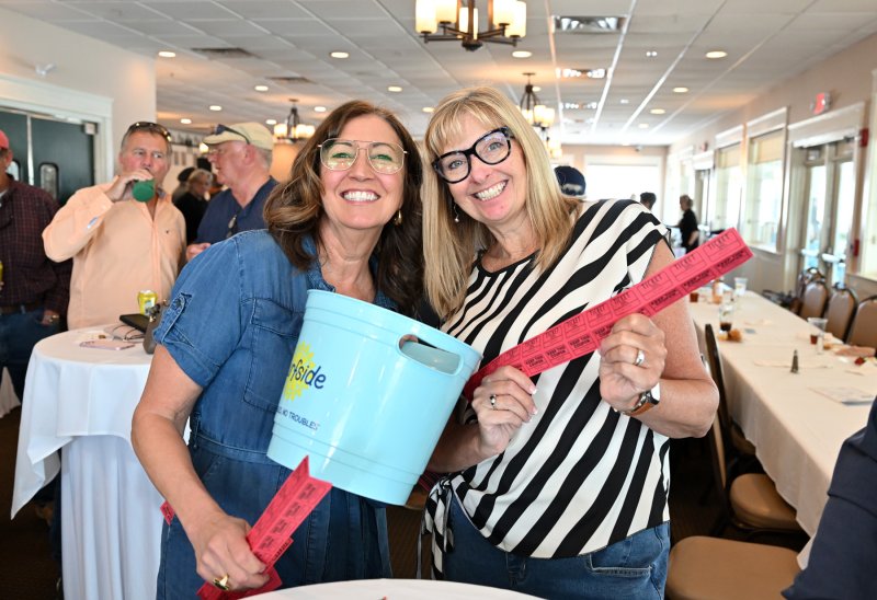 Jeannie Mack, left, and Mary Lawson sell 50/50 tickets.