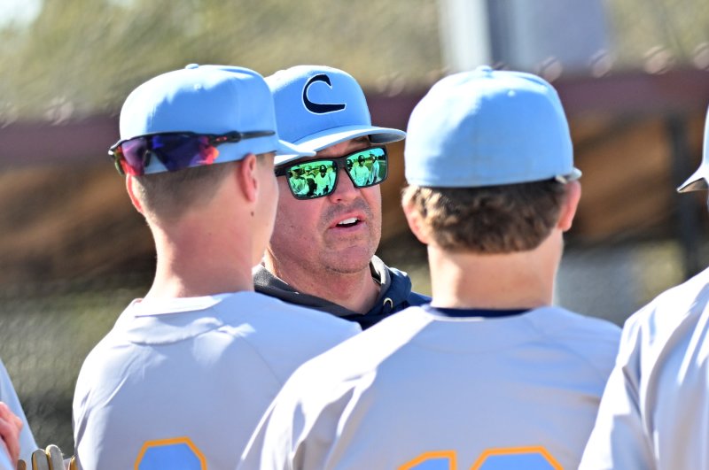 Cape coach Ben Evick speaks with his players during a field change.
