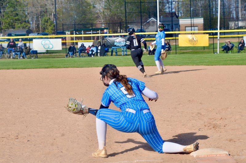 Cape junior Madi O’Malley keeps her foot on first for the out.