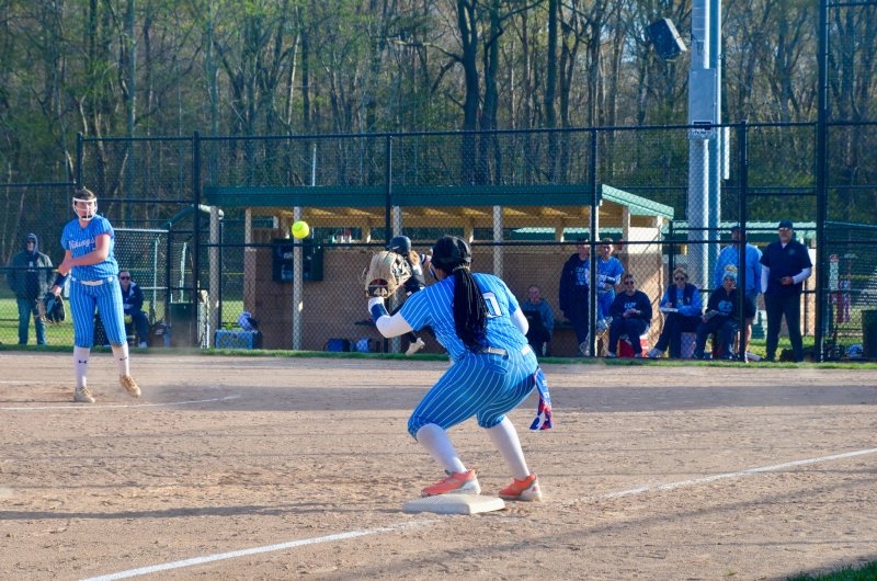 Cape sophomore Sara Craig makes a throw to classmate Jordynn Bowe for a force out at third base.