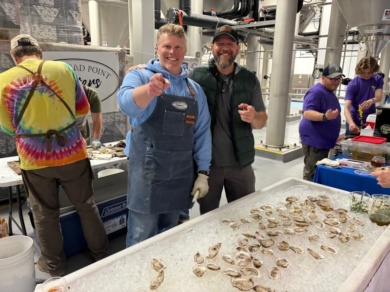 The Dogfish Head Weekend of Compelling Ales and Spirits featured a typical Mid-Atlantic favorite, raw oysters, provided by Arrowhead Point Oysters, and shucked and served by Chad Heers, left, and Will Revels. RYAN MAVITY PHOTOS