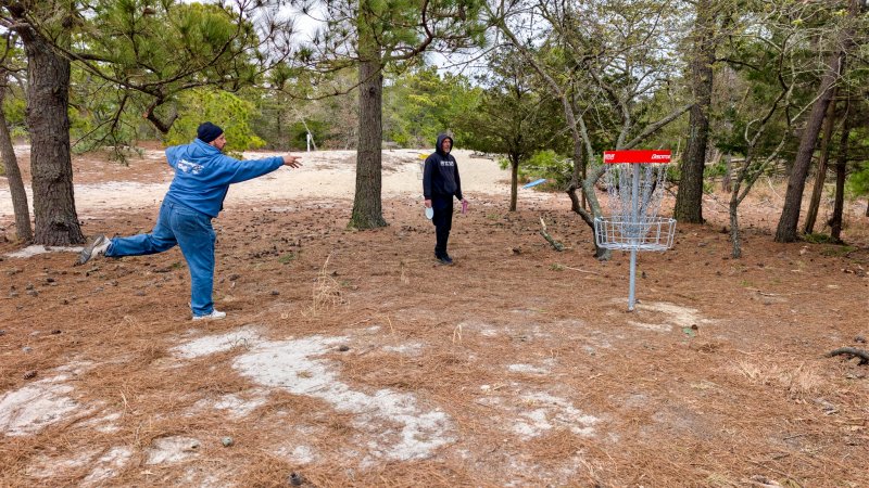 Miguel Garces tosses his disc into one of the new red baskets.