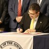 Gov. Matt Meyer signs an executive order Feb. 26. OFFICE OF THE GOVERNOR PHOTO
