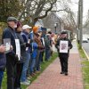 The Rev. Mark Harris holds a sign that reads, “Telling the Truth is Revolution,” as he walks down a line of silent protesters opposing the U.S. conflict in the Middle East at a peace vigil outside the Zwaanendael Museum in Lewes March 15. ELLEN MCINTYRE PHOTOS