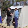 Mike Agnew, Tharros tent village executive director, left, talks to Khalil Saliba, Lewes deputy mayor, in front of a one of the new tents March 4. Tharros will be installing 28 tents and platforms between now and May. Organizers said Tharros will open April 1, about two weeks late because of the recent snow. BILL SHULL PHOTOS