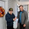 Tito Martinez, left, receives his Friday food delivery from Richard Chambers, a Meals on Wheels volunteer driver. Martinez was one of 14 clients on Chambers’ route outside Lewes and Rehoboth Beach. The Lewes group of volunteers has 19 routes in the area. BILL SHULL PHOTOS