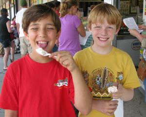 Aidan McAnelly, left, and Spencer King choose the day's winner, Cookie Dough Rock Slide, as their favorite new ice cream flavor.