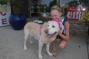 Maddie, who just came from a workout still wearing her iPod and scarf, poses for a photo with her owner, Caroline Lindsay. BY STEVEN BILLUPS