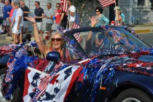 Claire Wilson, left, and Angie Tilton of Lewes wave to the crowd. BY RON MACARTHUR