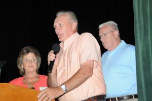 Rep. Dave Wilson tells the 40th anniversary luncheon crowd what CHEER means to his constituents while Arlene Littleton, executive director of CHEER, and Rep. Harvey Kenton of Milford look on.