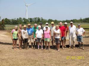 Shown are wetlands mitigation planting volunteers (l-r) Jolie Wax, Tessa Montane, Madeline Foster, Pres Lee, Bob Hume, Mary Ellen Hume, Dave Webber, Tracy Mulveny, Joan Reader, Bill Reader, Evelyn Maurmeyer, Bob Gibson, Dave Bernheisel, John Kyritsis and Irv Eberhart. BY OVERFALLS FOUNDATION
