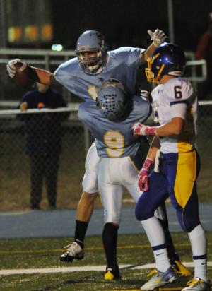 Cape wide receiver Andrew Grau is congratulated by teammmate Jerome Johnson after a long reception from quarterback Diaz Nardo. BY DAN COOK