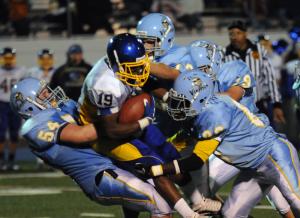 The Cape defense pulls down Central's DeShawn Sheppard. BY DAN COOK