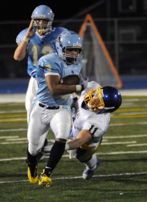 Cape senior running back Jerome Johnson runs out of the tackle attempt of Central's Jesse Long. BY DAN COOK
