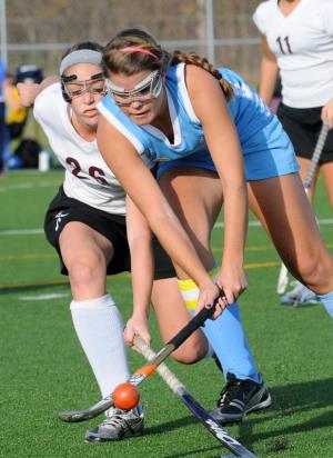 Cape's Jacki Coveleski, right, battles for the ball with Milford's Alyssa Mills. BY DAN COOK