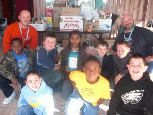 Students help gather food items for the Carolling on the Circle festivities. Pictured are (l-r) in front row Mckenzie Sanford, Michael Jones and Jeffrey Whitcomb; in the second row are Shawn Jones, Damion Sidebothom, Matt Perry, Justin Harrigan and Christopher Shea; in the back row are teachers Scott Pierce and Tim Biggs. SOURCE SUBMITTED