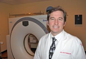 Dr. Jonathan Patterson stands in front of the MRI machine in his office, Ocean Medical Imaging in Milton. BY NICK ROTH