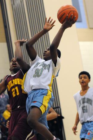 Mariner forward Corey Corbin glides to the hoop in the first half of the Viking victory. BY DAN COOK